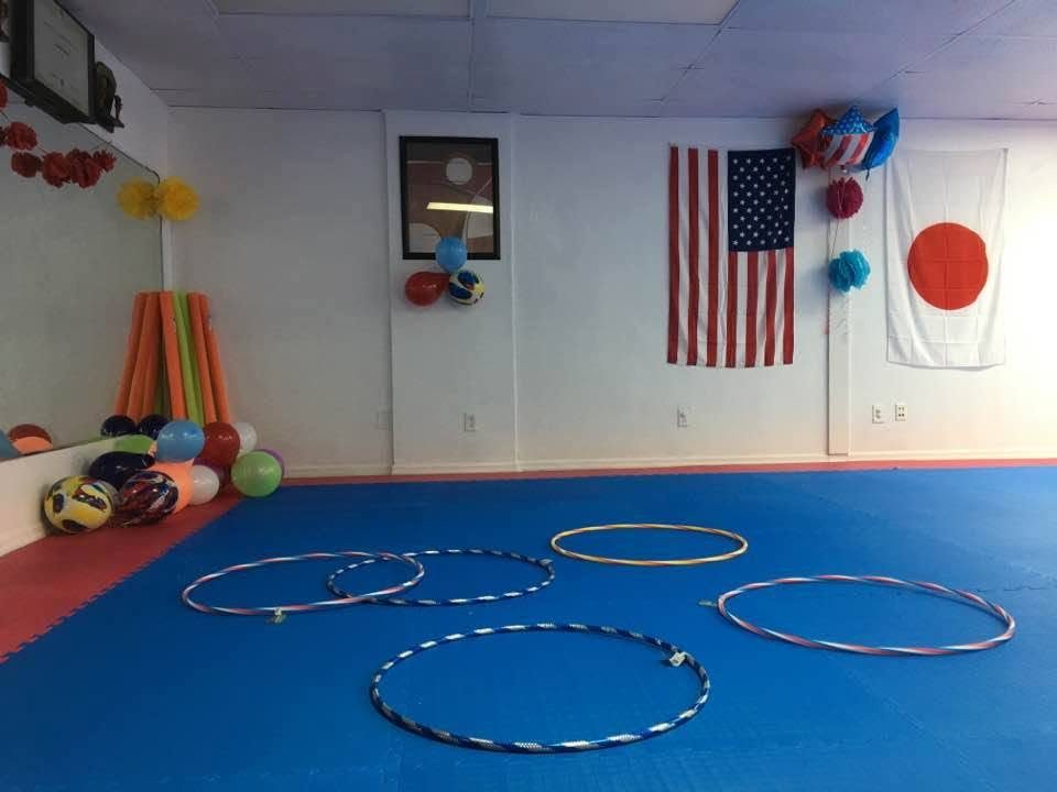 Dojo wall with American and Japanese flags above the mats